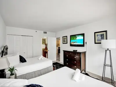 a bedroom with two beds and a flat screen tv at Perfect Ocean View Condo Beach Service 1109 in Miami Beach
