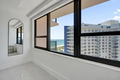 a room with windows with a view of the ocean at Relax in Style 3BR 2BA Beach Condo in Oceanfront Resort Pools Gym Sauna 1507 in Miami Beach