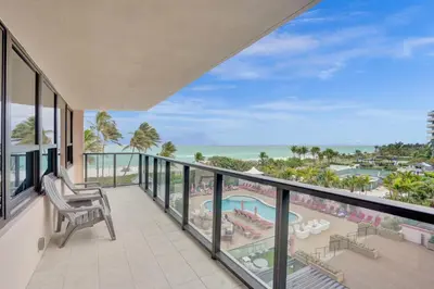 a balcony with a view of the beach and the ocean at Resort beach condo w beach service 601 in Miami Beach