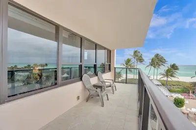 a balcony with chairs and a view of the ocean at Resort beach condo w beach service 601 in Miami Beach