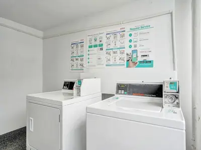 a white laundry room with a washer and dryer at Lovely Ocean View Condo Beach Service 704 in Miami Beach