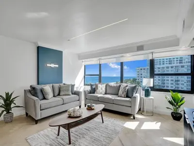 a living room with two couches and a table at Spacious Ocean View Condo Beach Service 803 in Miami Beach