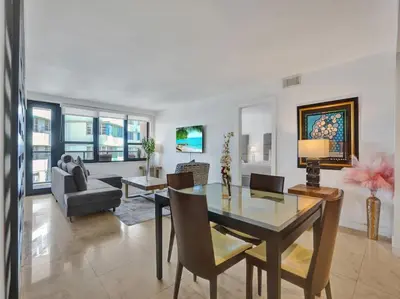 a living room with a dining table and a couch at Luxury Ocean View Condo Beach and Resort 1216 in Miami Beach