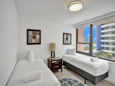a bedroom with two beds and a window at Spacious Ocean View Condo Beach Service 509 in Miami Beach