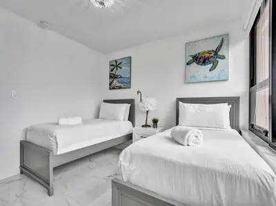 two beds in a room with white walls at Ocean View Retreat Beach Service 1603 in Miami Beach