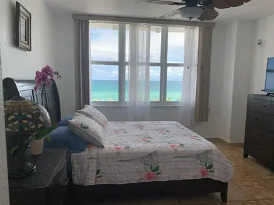 a bedroom with a bed and a large window at Pavilion in Miami Beach