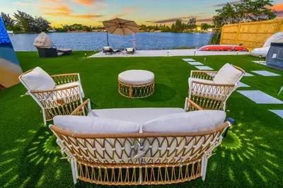 a group of chairs and tables on the grass at Tulum Villa in Miami