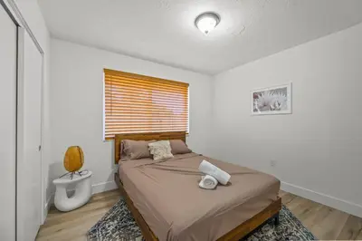 a small bedroom with a bed and a window at Tulum Villa in Miami
