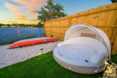 a boat sitting on the grass next to a fence at Tulum Villa in Miami