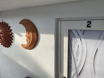 a clock on a wall next to a door with a mask at Luna y Sol Calle 8 in Miami