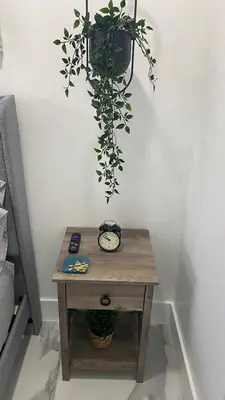 a table with a clock and a potted plant at Luna y Sol Calle 8 in Miami