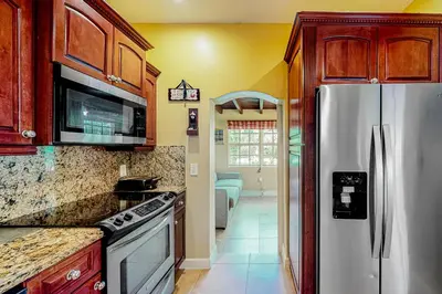 a kitchen with a stainless steel refrigerator at Go with the Flow in Hollywood