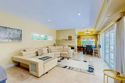 a living room with couches and a dining room at Go with the Flow in Hollywood