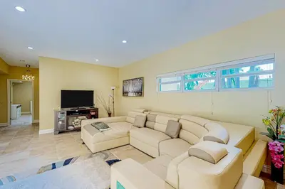 a living room with a couch and a tv at Go with the Flow in Hollywood