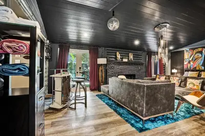 a living room with a couch and a fireplace at Kiki Grand Suite - Men's Clothing optional Guest Houses in Fort Lauderdale