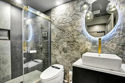 a bathroom with a toilet and a sink and a shower at Kiki Grand Suite - Men's Clothing optional Guest Houses in Fort Lauderdale