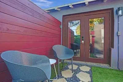 two chairs and a table in front of a house at Kiki 1 - Men's Clothing optional Guest Houses in Fort Lauderdale