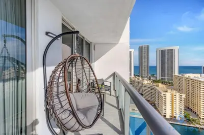 a hanging chair on a balcony with a view of the city at Infinite View Balcony Gym Amaizing Pool in Hallandale Beach