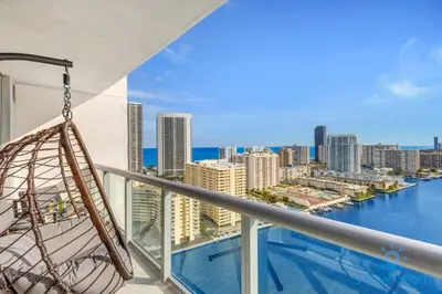 a balcony with a hammock and a view of the city at Infinite View Balcony Gym Amaizing Pool in Hallandale Beach