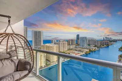 a hammock on a balcony with a view of the city at Amaizing Pool Infinity View w Balcony Gym in Hallandale Beach
