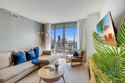 a living room with a couch and a table at Amaizing Pool Infinity View w Balcony Gym in Hallandale Beach