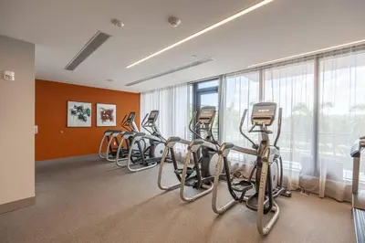 a fitness room with a row of exercise bikes at Stunning Apartment in Downtown Doral in Miami