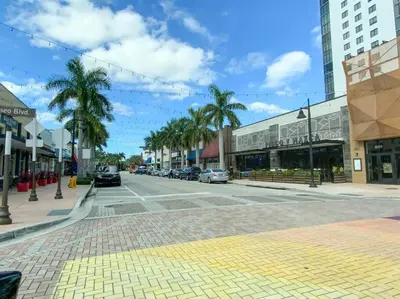 a city street with cars parked on the street at Stunning Apartment in Downtown Doral in Miami