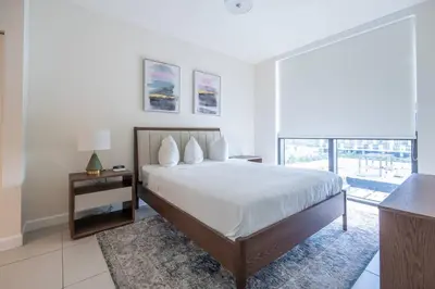 a bedroom with a large bed and a large window at Stunning Apartment in Downtown Doral in Miami