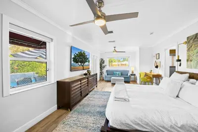 a white bedroom with a bed and a window at Palms Retreat! Giant Heated Pool-HotTub-FirePit-5Min2Beach-Pets-EV Chgr in Fort Lauderdale