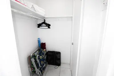 a small hallway with a white wall and a shelf at Castle 1118 Studio BayView Direct Beach Access, Tennis, Pool, Restaurants, Free Parking in Miami Beach