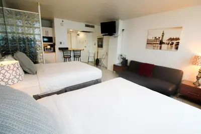 a hotel room with two beds and a couch at Castle 1120 Bayview Studio, Beach access, Pool, Tennis, Free parking in Miami Beach