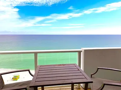 a table and chairs on a balcony with the ocean at Castle 1527 Studio Balcony Direct Beach Access, Pool, Tennis, Free Parking in Miami Beach