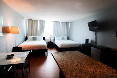 a hotel room with two beds and a table at Castle 618 in Miami Beach
