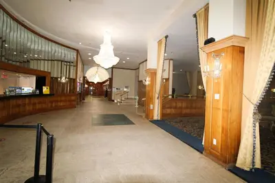 an empty hallway of a building with a chandelier at Castle 727 Studio with balcony and Ocean view, Pool, Tennis, Beach Access, Free Parking in Miami Beach