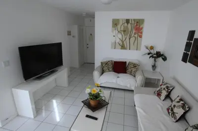 a living room with a couch and a tv at Castle B6 in Miami Beach