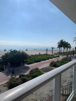 a view of the beach from the balcony of a condo at Castle BTH2 Stunning Oceanfront Townhouse, Private Beach Access, Private Pool Access, Tennis and Free Parking! in Miami Beach