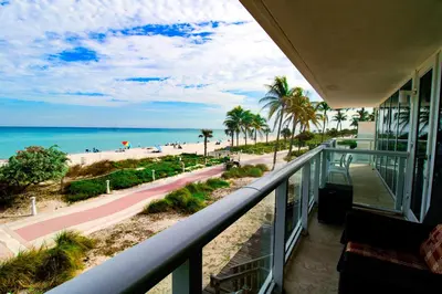 a balcony with a view of the beach and the ocean at Castle BTH2 Stunning Oceanfront Townhouse, Private Beach Access, Private Pool Access, Tennis and Free Parking! in Miami Beach