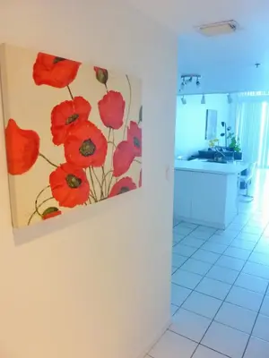 a painting of red flowers on a wall in a kitchen at Castle M4 Beachfront Balcony Loft, FREE Parking, Pool, Tennis, Beach Access in Miami Beach