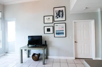 a living room with a tv and a table with a television at Castle PH12 Spacious Bay View Penthouse, Pool, Tennis, Free Parking in Miami Beach