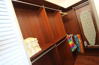 a closet with wooden paneling and folded towels at Castle PH15 Spacious Penthouse with Balcony, Beach Access, Pool, Tennis, Free Parking in Miami Beach