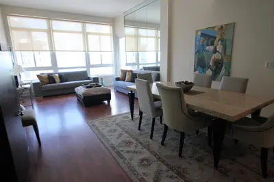 a living room with a table and chairs and a couch at Castle PH15 Spacious Penthouse with Balcony, Beach Access, Pool, Tennis, Free Parking in Miami Beach