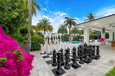 a large chessboard in the courtyard of a house at MIA MANSION W/ POOL / BBQ /CABANNA / OUTDOOR BAR in Tamiami