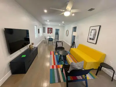 a living room with a yellow couch and a tv at Best location Miami Brickell 3 bedroom Home in Miami