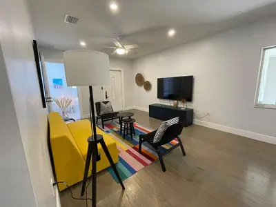 a living room with a yellow couch and chairs at Best location Miami Brickell 3 bedroom Home in Miami