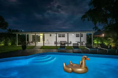 a swimming pool with a toy duck in front of a house at New Tropical Oasis Retreat in Miami in Miami