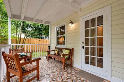 a porch with two wooden chairs and a door at Casa Del Rio 4 Bed 2 Bath Next to River 1826 in Miami
