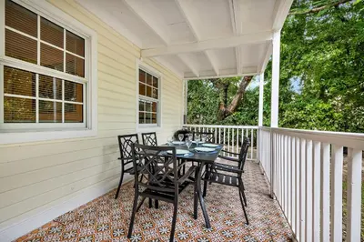 a table and chairs on the porch of a house at Casa Del Rio 4 Bed 2 Bath Next to River 1826 in Miami