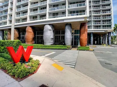 a large building with a red sign in front of it at ICON W BRICKELL BY IMD MIAMI Splendid Ocean View 2BR 1BA in Miami