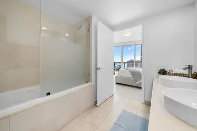 a white bathroom with a tub and a sink at ICON W BRICKELL BY IMD MIAMI Splendid Ocean View 2BR 1BA in Miami