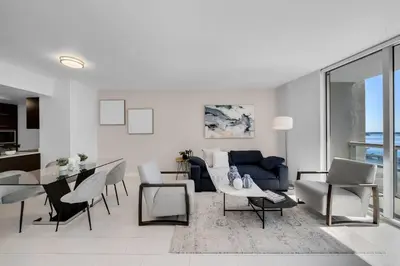a living room with a blue couch and a table at ICON W BRICKELL BY IMD MIAMI Splendid Ocean View 2BR 1BA in Miami
